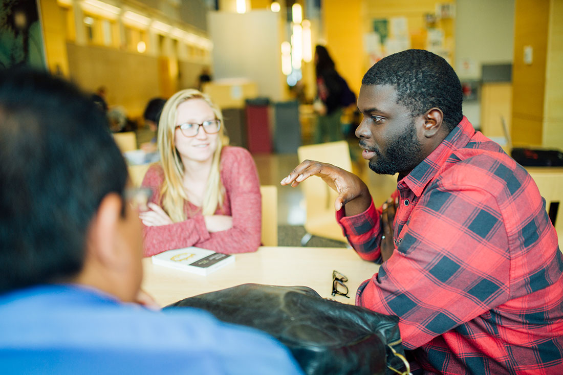 Photo of students sitting with professor