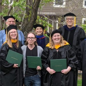 PhD Students posing with degrees