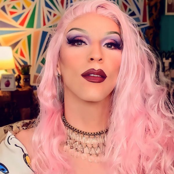 Photo of Krisa Gonna, a woman with light pink hair and dramatic makeup