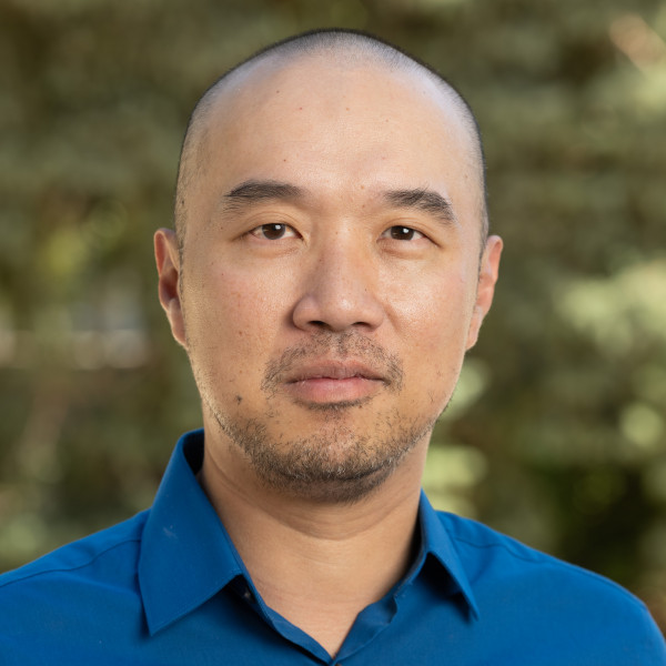 Headshot of Professor Samuel M. THam in a blue shirt