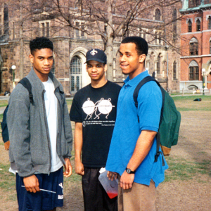 Group of three men standing outside together