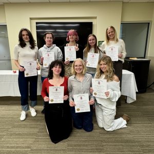 Group of students inducted into the Lambda Pi Eta honor society