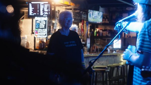 Yvette Rippee, the "Pop Punk Grandma," smiling at a singer during a punk rock concert