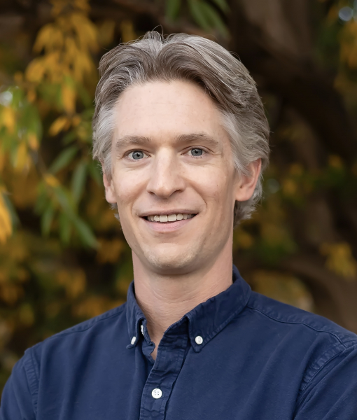 Headshot of Nick Marx wearing blue button-up shirt