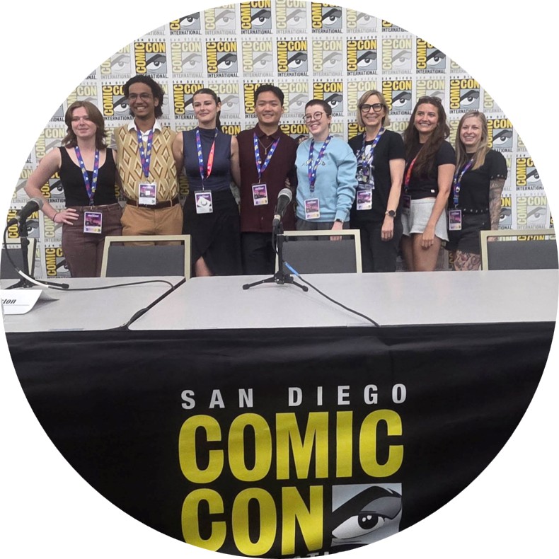 students standing behind a conference table