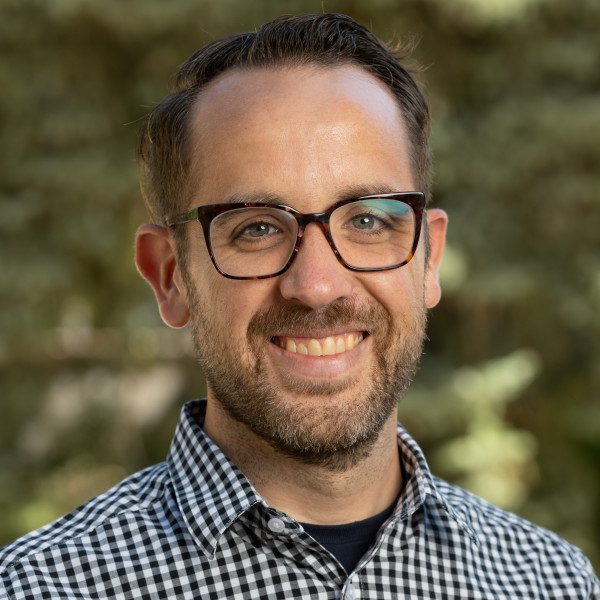 Headshot of David Wolfgang in a plaid shirt
